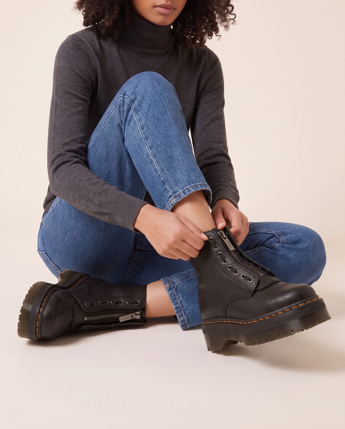 Chunky Platform Leather Ankle Boots with Front Zip — zipping up the boot, seated