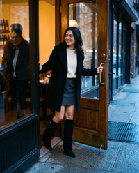 Women's Black Slouchy Suede Knee High Boots — arriving at a wine bar at dusk