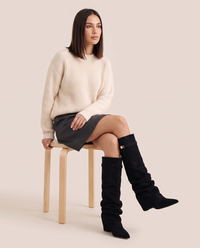 Women's Black Slouchy Suede Knee High Boots — worn seated