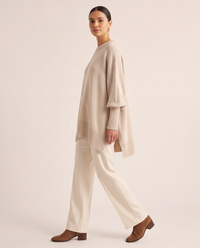Women's Oversized Crew Neck Knit Sweater — side view, asymmetric hem