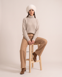 Ivory Faux Fur Hat with Wide Rolled Brim — worn seated