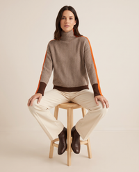 Striped Herringbone Turtleneck Sweater — worn seated