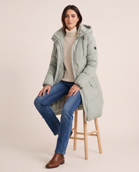 Women's Long Winter Coat with Faux Fur Lined Hood — worn seated