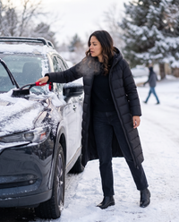 Longline Hooded Puffer Coat with Welt Pockets — clearing snow off the car on a winter morning