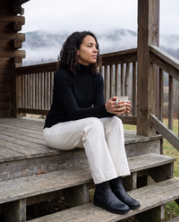 Merano Classic Solid Knit Turtleneck Sweater — with tea on a Vermont cabin porch