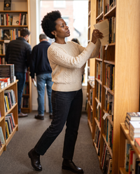 Marettimo Classic Cable Knit Pullover Sweater — browsing a Brooklyn bookstore
