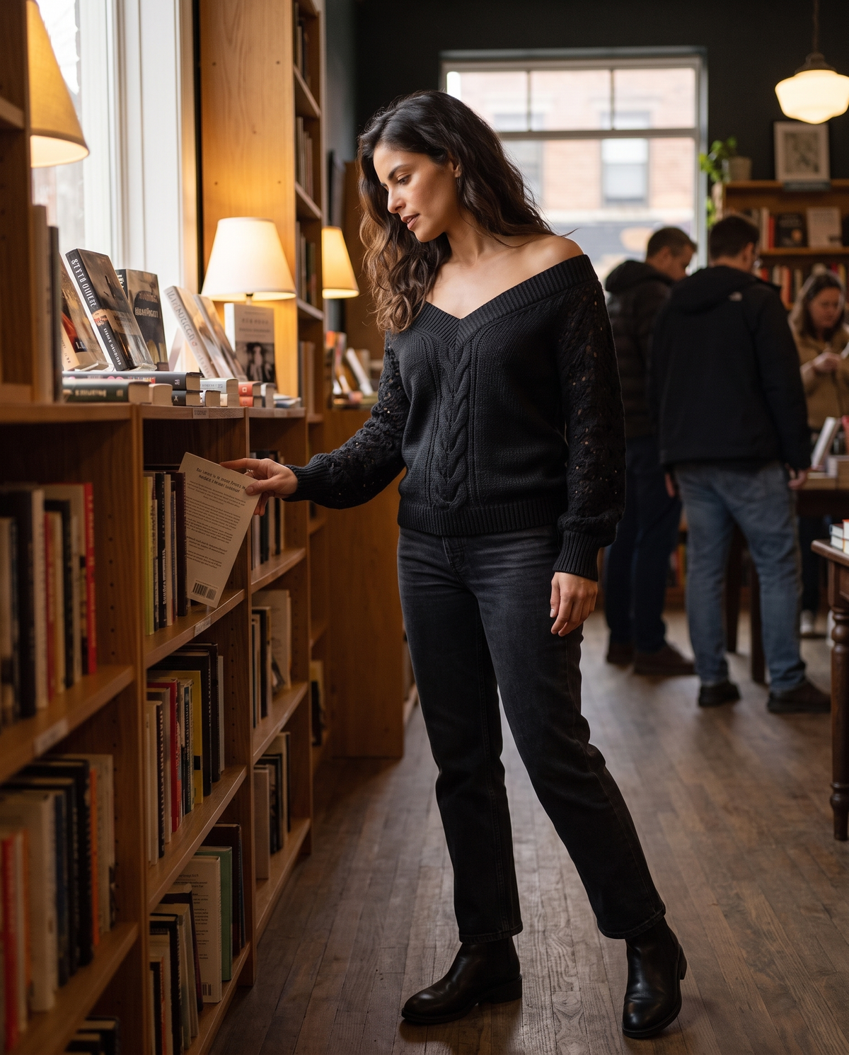 Ischia Relaxed Off-Shoulder Cable Knit V-Neck Sweater — browsing a Brooklyn bookstore