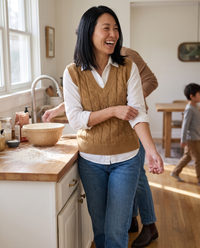 Falmouth Versatile Cable Knit Sweater Vest — baking at home on a Sunday morning