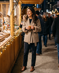 Wool-Blend Wrap Coat with Plush Cuffs — at a holiday market at night
