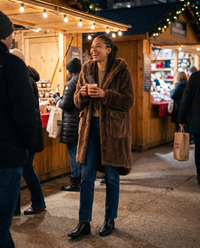 Hooded Faux Fur Longline Coat — at a holiday market at night