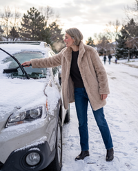 Faux Fur Coat with Quilted Lining — clearing snow off the car on a winter morning