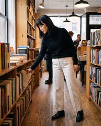 Marylebone Slim-Fit Brushed Knit Turtleneck Sweater — browsing a Brooklyn bookstore