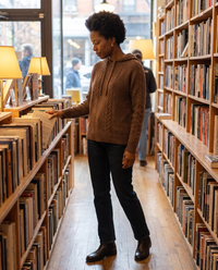 Marzamemi Cozy Hooded Cable Knit Pullover Sweater — browsing a Brooklyn bookstore