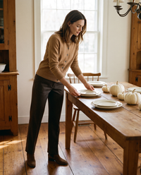 Merino Wool & Cashmere Cardigan — light brown, worn setting a Thanksgiving table