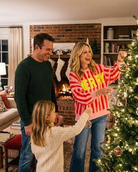 Women's Christmas Sweater, Striped Merry Sweatshirt — worn decorating the Christmas tree with family by the fireplace