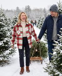 Christmas Plaid Flannel Shacket with Pockets — red, cutting a Christmas tree at a snowy Vermont tree farm