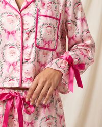 Women's Christmas Pajamas, Satin Bow-Cuff PJ Set — close-up of Santa print, pink piping, pocket and ribbon bow cuff