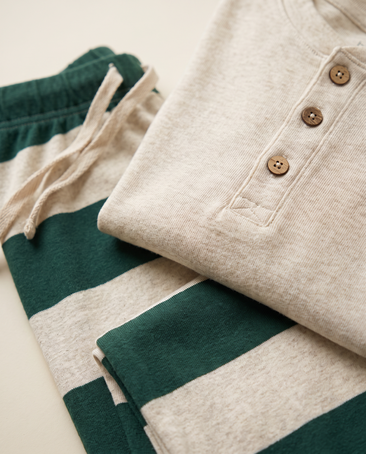 Family Christmas Pajamas, Green & Cream Stripe — henley buttons and stripe fabric close-up