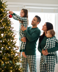 Matching Family Christmas Pajamas, Green Buffalo Plaid — family decorating the Christmas tree