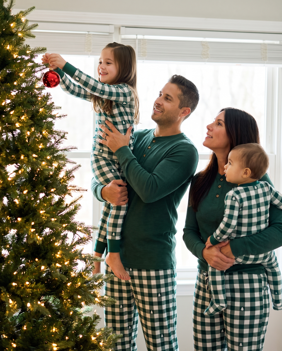 Matching Family Christmas Pajamas, Green Buffalo Plaid — family decorating the Christmas tree