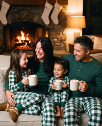 Matching Family Christmas Pajamas, Green Buffalo Plaid — family with hot cocoa by the fireplace on Christmas Eve