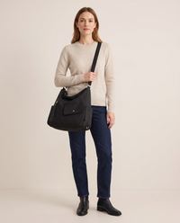 Women's Convertible Shoulder Bag, Crossbody Backpack Purse — black, studio front, worn crossbody