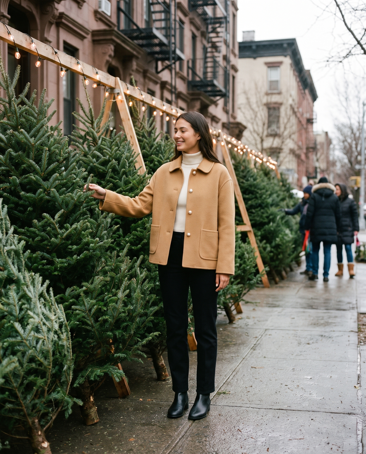 Women's Cropped Cashmere Coat in camel worn while choosing a Christmas tree on a Brooklyn sidewalk