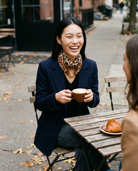 Women's Silky Leopard Neck Scarf in Brown worn at a West Village cafe terrace