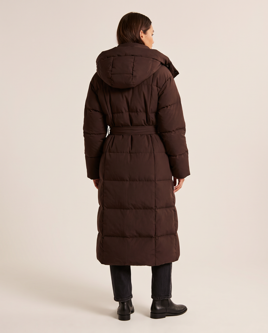 Women's Long Belted Puffer Coat in chocolate brown — studio back view with hood