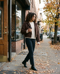 Women's Oversized Cropped Faux Suede Jacket in brown worn leaving a Brooklyn café with coffee in November