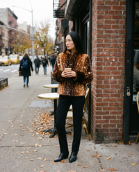 Women's Brown Fawn Print Faux Fur Jacket with Contrast Cuffs — worn outside a New York cafe in late autumn with a latte