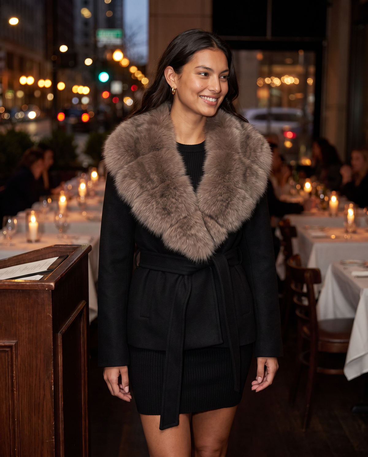 Belted black wool jacket with fur collar worn to a holiday dinner