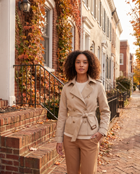 Beige short trench jacket worn on a Georgetown rowhouse street