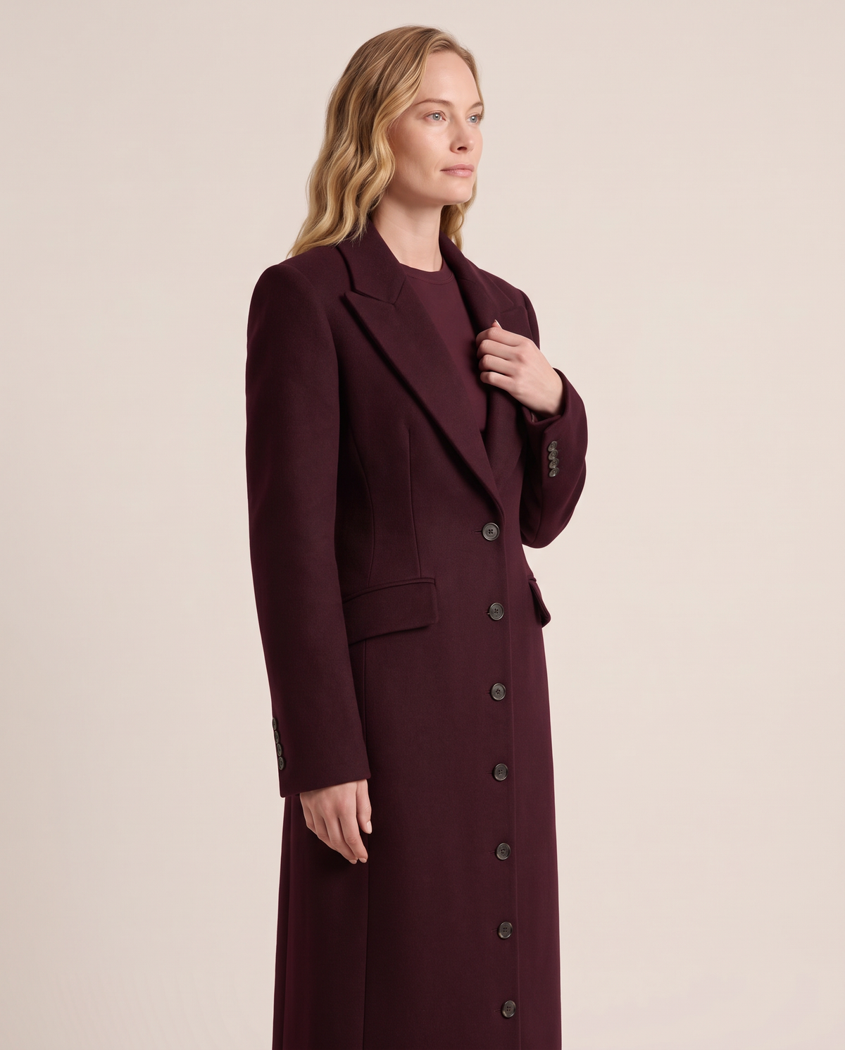 Tailored maxi coat notch lapel and button detail, three-quarter view
