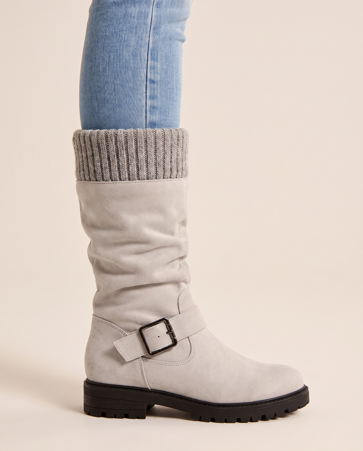 Ribbed knit cuff, buckle strap and lug sole detail