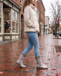 Grey knit cuff boots worn on a small-town main street in fall