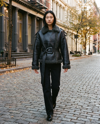 ONORA black faux leather shearling aviator jacket for women - New York SoHo cobblestone street