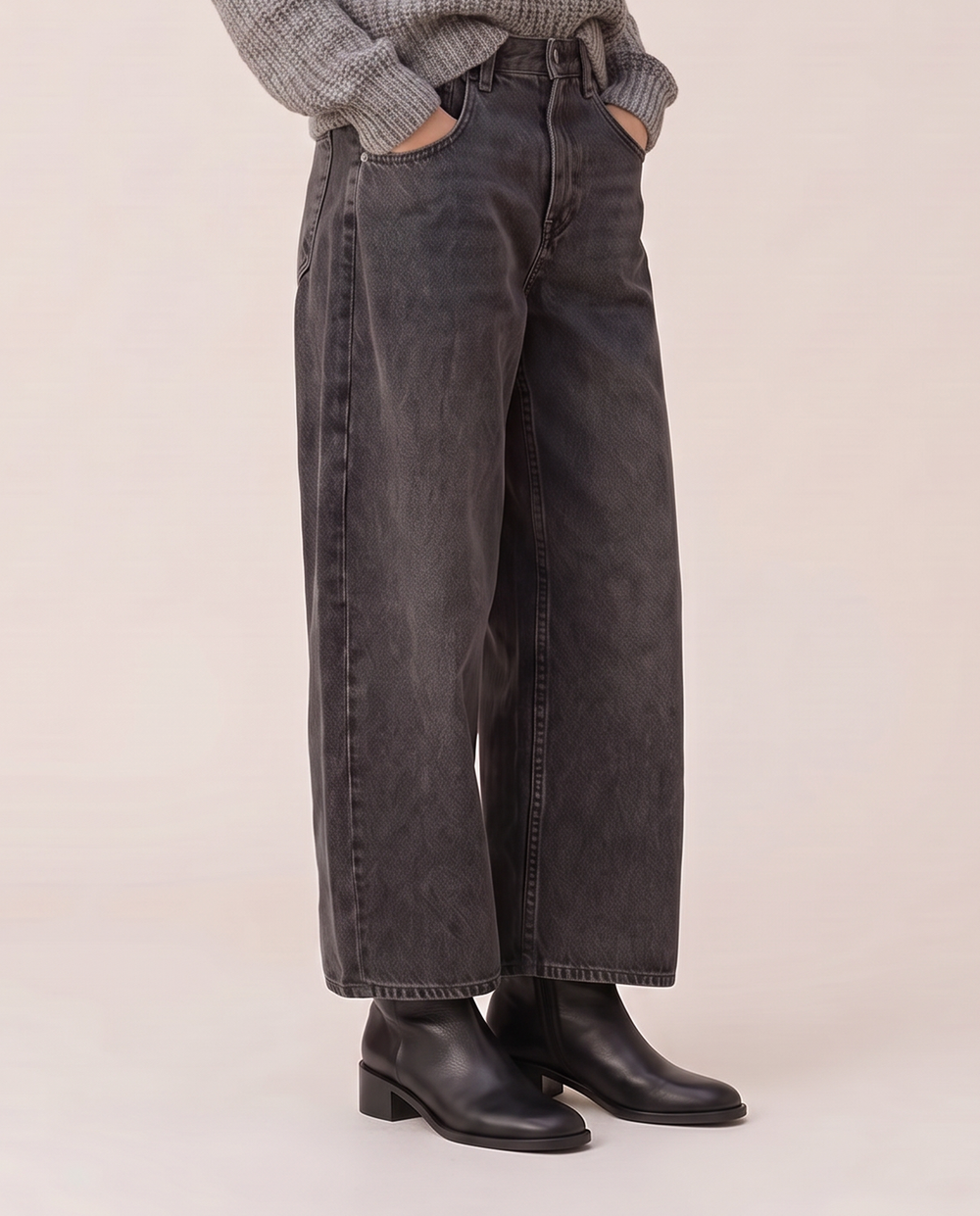 Baggy black wash jeans, waist-down view