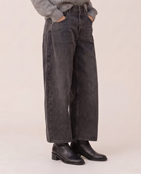 Baggy black wash jeans, waist-down view