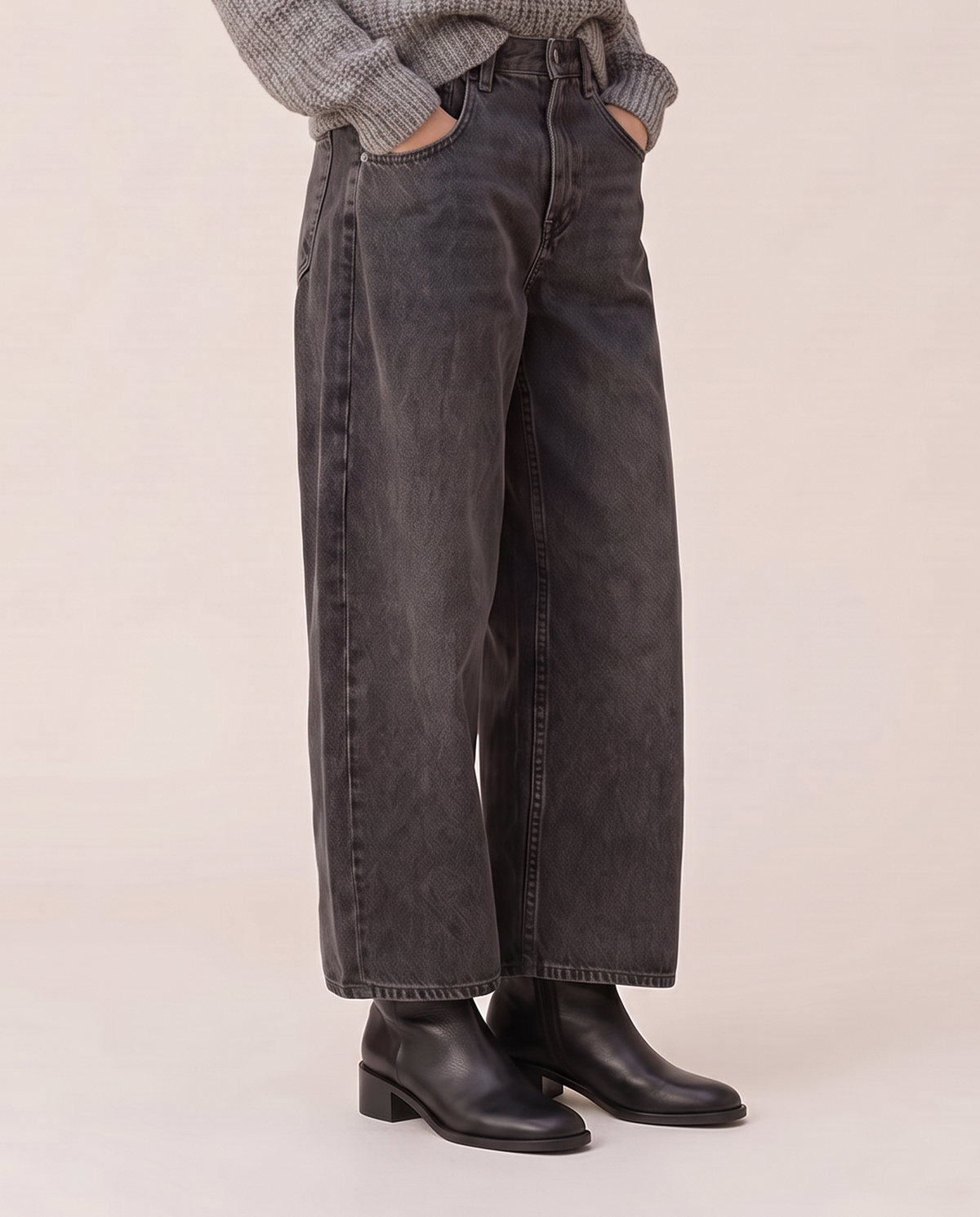 Baggy black wash jeans, waist-down view