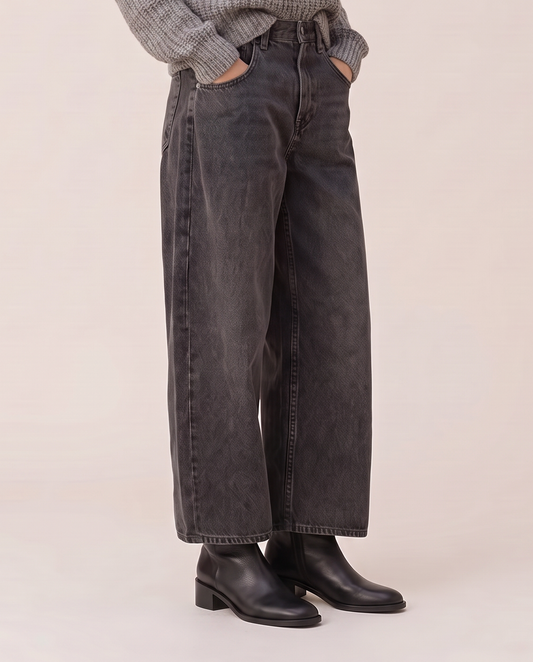 Baggy black wash jeans, waist-down view