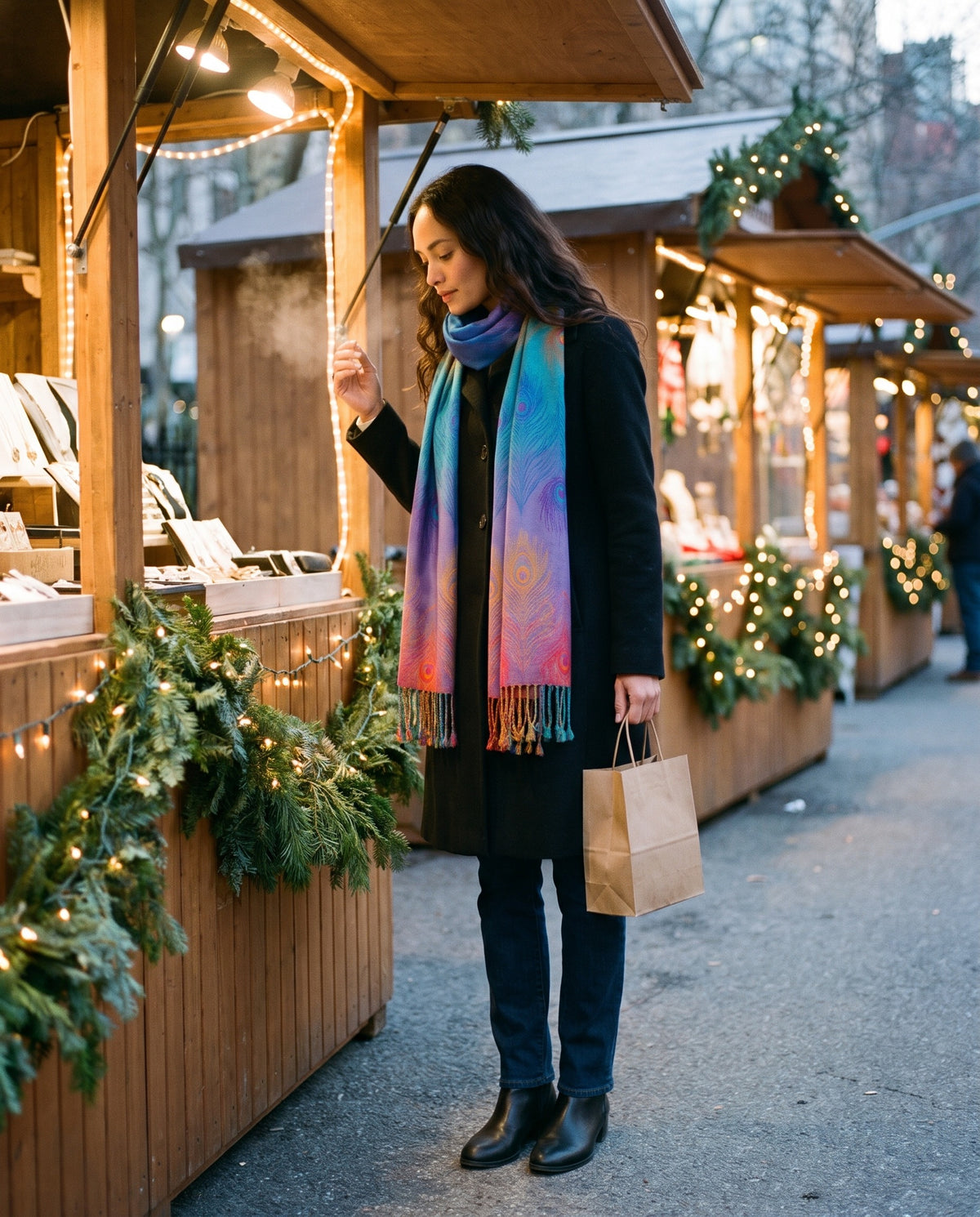 Women's Cashmere Blend Wrap Scarf in Blue — worn over a black coat at an outdoor holiday market