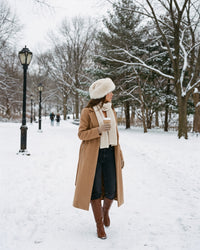 Ivory Faux Fur Hat with Wide Rolled Brim — worn on a snowy walk in Central Park, New York
